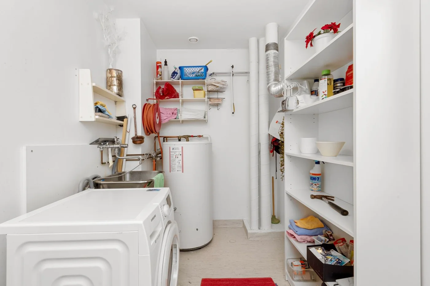 A water heater installed in a residential laundry room